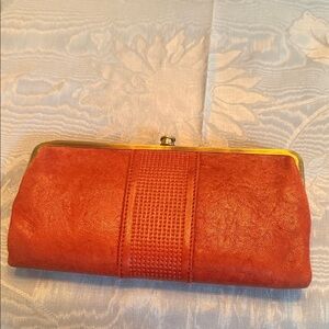 Hobo clutch wallet in mottled red color.